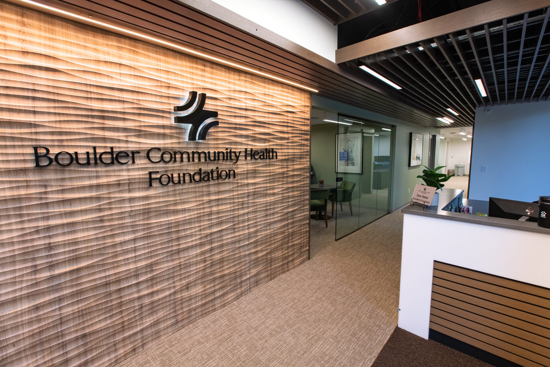 Boulder Community Health Foundation reception and entry with dimensional wood signage wall