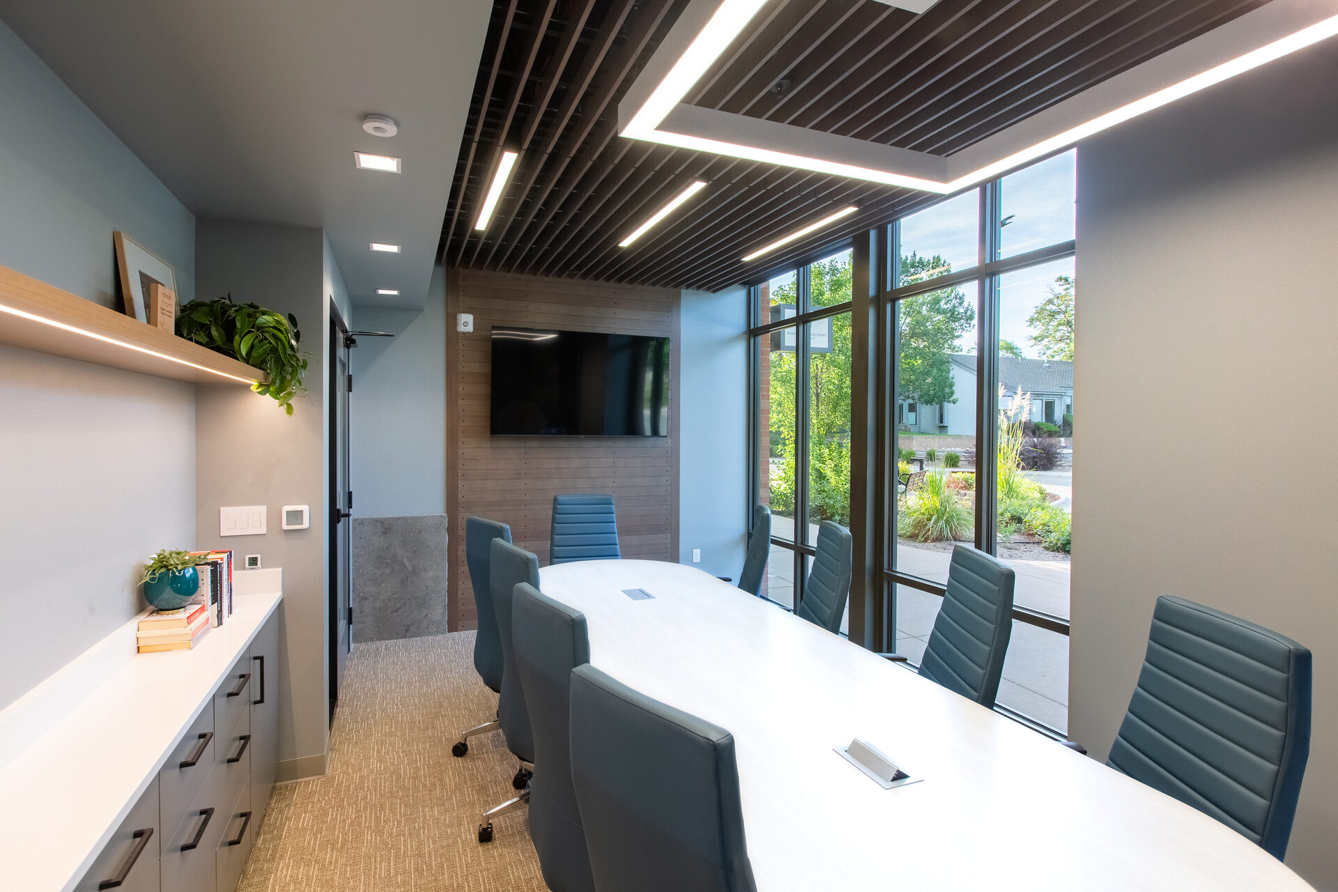 Conference room with wood slat feature wall and full-height glazing