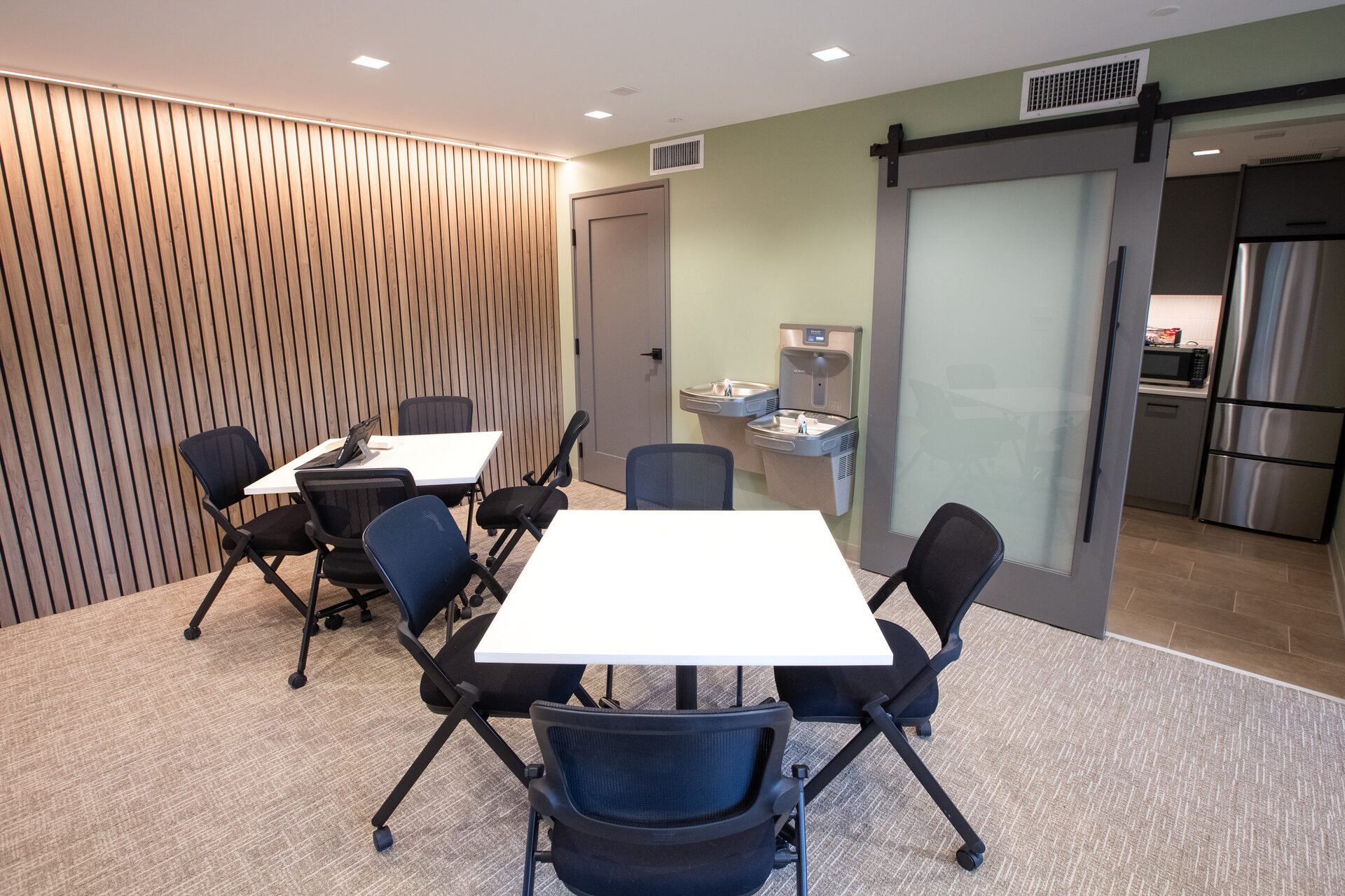 Break room and flex meeting space with sliding barn door